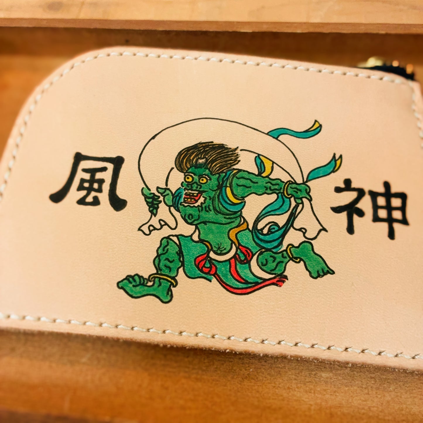 風を操る神の力を、あなたの日常に。風神の手描きイラスト入り、ヌメ革L字ファスナー財布